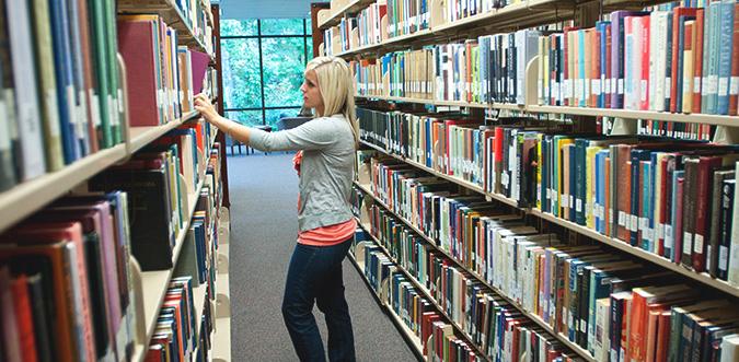 Student in library stacks